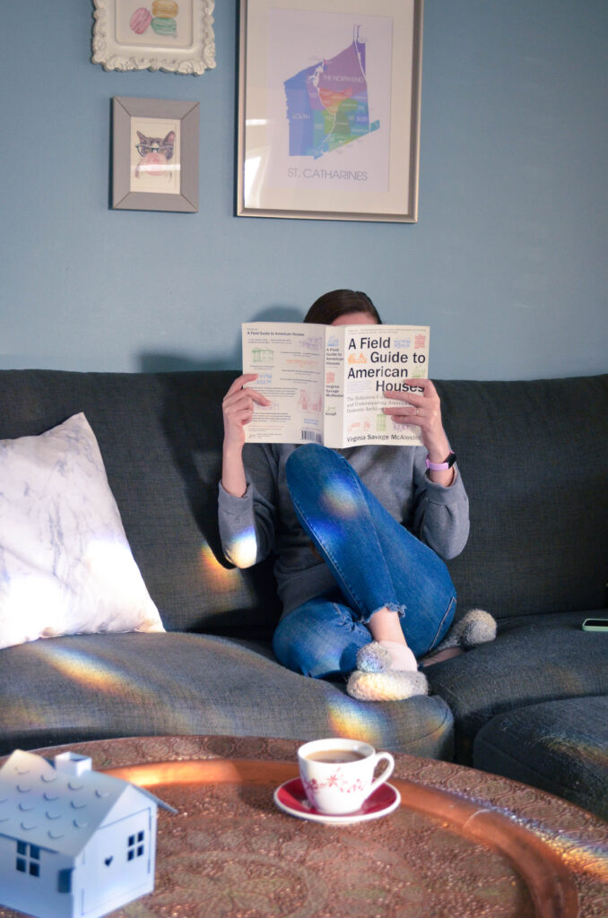 Woman in cozy scene with a book and tea.