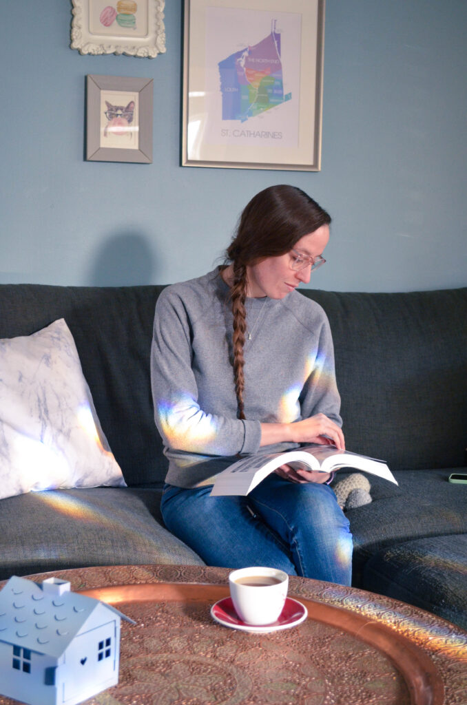 Woman in cozy scene with a book and tea.