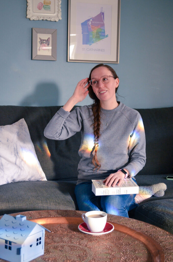 Woman in cozy scene with a book and tea.